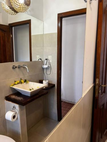 a bathroom with a sink and a mirror at Kamay Apart Cafayate in Cafayate