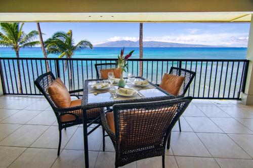 Noelani 410 في Kapalua-West Maui Airport: طاولة وكراسي على شرفة مطلة على المحيط