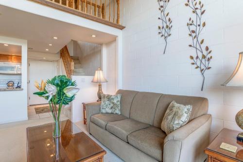 a living room with a couch and a table at Hono Kai C8 in Wailuku