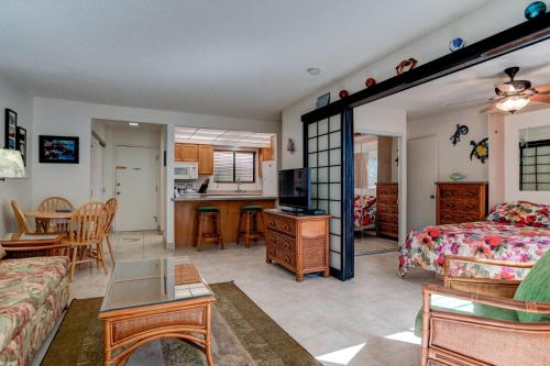 a living room with a bed and a kitchen at Hono Kai B15 in Maalaea
