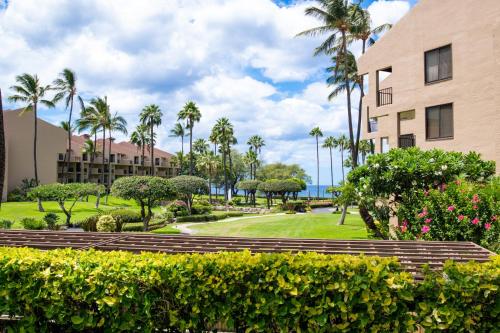 a park with palm trees and a building at Kamaole Sands 2-106 in Wailea