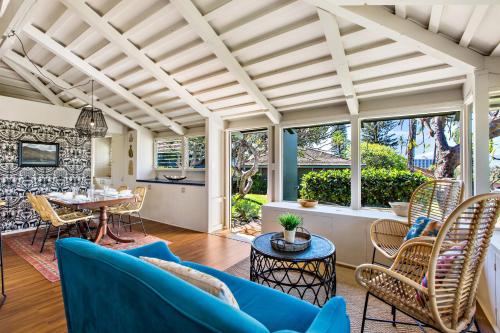 a living room with blue furniture and a table at International Colony 17 in Lahaina
