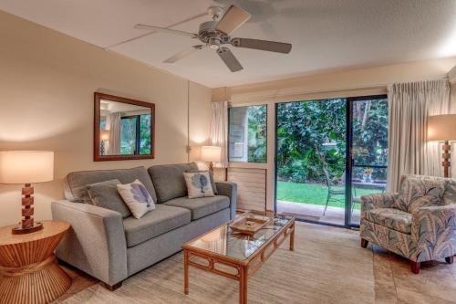 a living room with a couch and a table at Hono Kai A16 in Wailuku