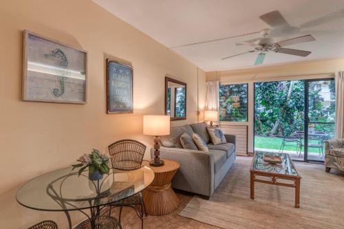 a living room with a couch and a table at Hono Kai A16 in Wailuku
