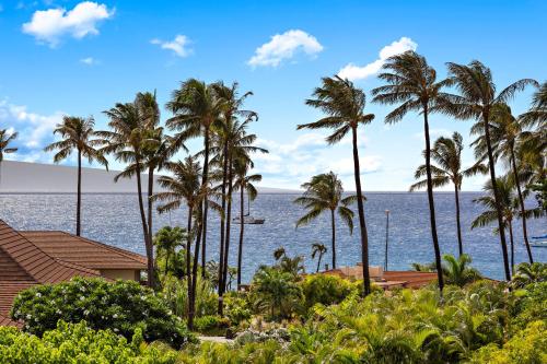 a view of the ocean from a resort with palm trees at Maui Kaanapali Villas A420 in Lahaina