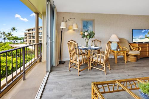 a patio with a table and chairs on a balcony at Maui Kaanapali Villas A420 in Lahaina