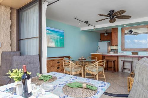 a living room and kitchen with a table and a dining room at Paki Maui 405 in Honokowai