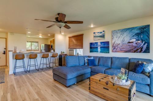 a living room with a blue couch and a bar at Kaanapali Plantation 54 in Lahaina