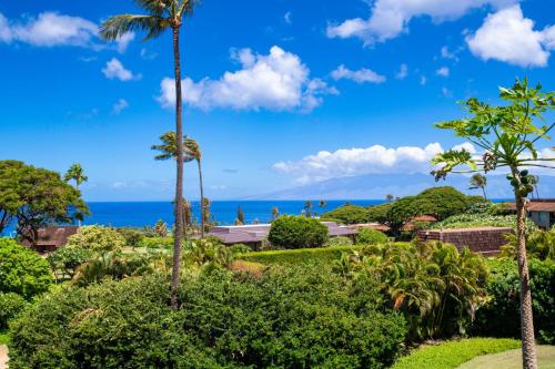 a view of the ocean from a resort with palm trees at Kaanapali Plantation 54 in Lahaina