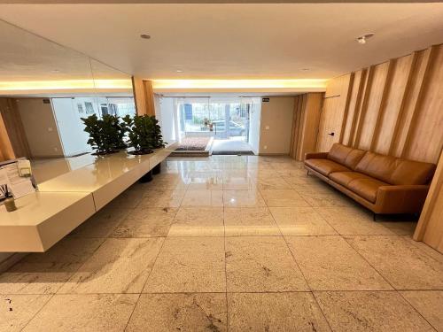 a living room with a couch and a table at LK Santo Antônio 1 in Belo Horizonte