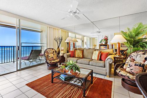 a living room with a couch and a table at Hololani A203 in Kahana
