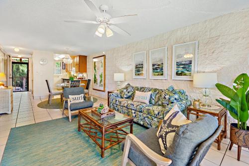 a living room with a couch and chairs at Kanai A Nalu 214 in Wailuku