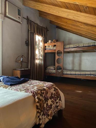 a bedroom with two bunk beds and a window at Arboleda in Jardín América