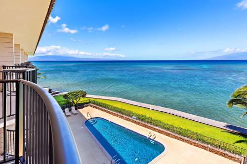 a view of the ocean from a balcony with a swimming pool at Kahana Reef 408 in Kahana