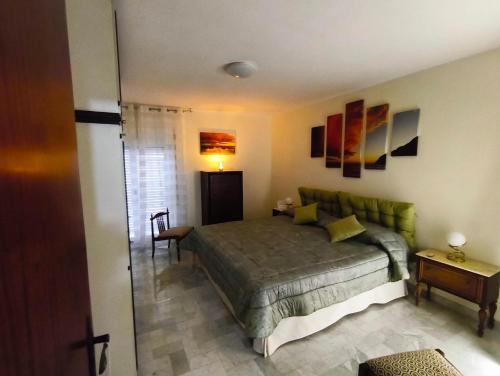 a bedroom with a green bed in a room at Franca la Sarta House in Castellana Grotte