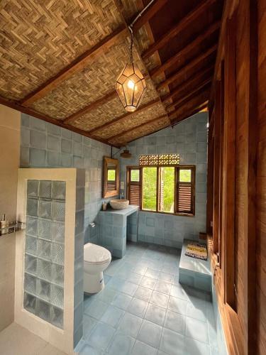 a bathroom with a toilet and a sink at Green vanilla Suite 1 in Silebeng