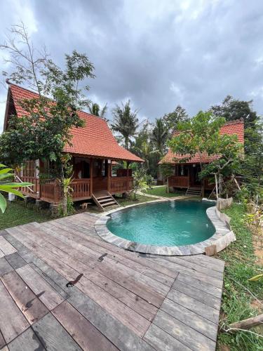 a villa with a swimming pool and a house at Green vanilla Suite 1 in Silebeng