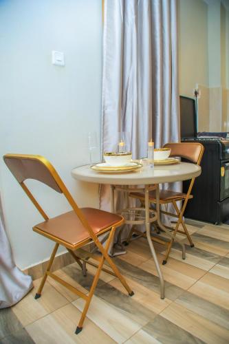 a table and chairs with candles on top of it at Graphite & Gold Suite in Ruiru