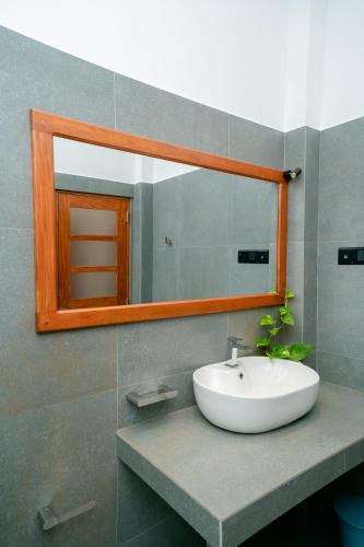 a bathroom with a sink and a mirror at Villa Balcony Bliss in Unawatuna