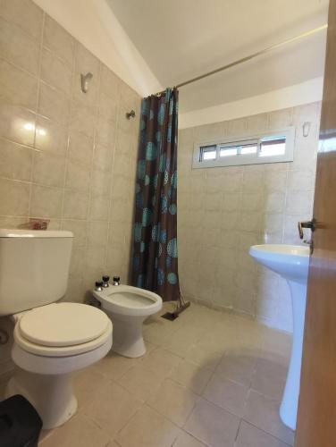 a bathroom with a toilet and a sink at Rincón del Rio San Antonio in San Antonio de Arredondo