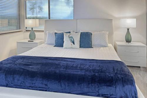 Golf and Tennis Community - Peaceful Pond Paradise - Pet friendly في ويسلي شابل: غرفة نوم بسرير كبير عليها شراشف ووسائد زرقاء