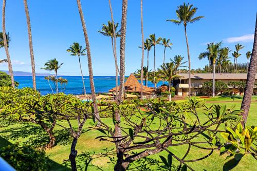 a view of the ocean from a resort with palm trees at Napili Shores H263 in Kapalua