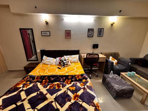 a bedroom with a bed and a living room at The night view in Noida