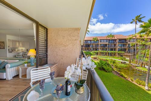a room with a balcony with a view of a resort at Papakea C209 in Honokowai