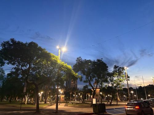 a street at night with cars driving down the street at Apartamento en pleno centro in Salto
