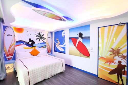 a bedroom with surfboards painted on the walls at Edinburgh 16 Inn in Hengchun South Gate