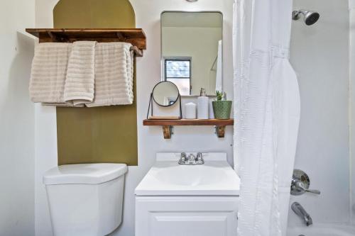 a bathroom with a toilet and a sink and a mirror at 1BR Near UofA, Work Desk, Gem Show Friendly in Tucson