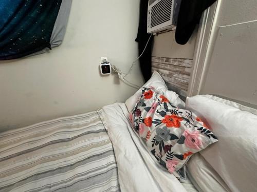 a bedroom with a bed with a pillow and an air conditioner at Grateful Hemphill C in Atlanta