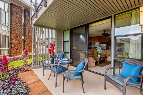 a patio with chairs and a table on a patio at Mahina Surf 117 in Honokowai