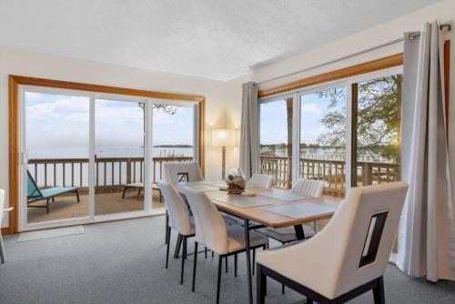 a dining room with a table and chairs at Adventures on the Bay - Bayfront Escape, Private Dock, Large Deck, and Lake Views! in Hudgins