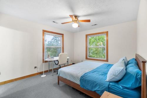 a bedroom with a bed and a ceiling fan at Adventures on the Bay - Bayfront Escape, Private Dock, Large Deck, and Lake Views! in Gwynn