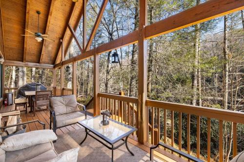 a screened in porch with a view of the woods at Serene Cabin Overlooking Large Pond in Brevard
