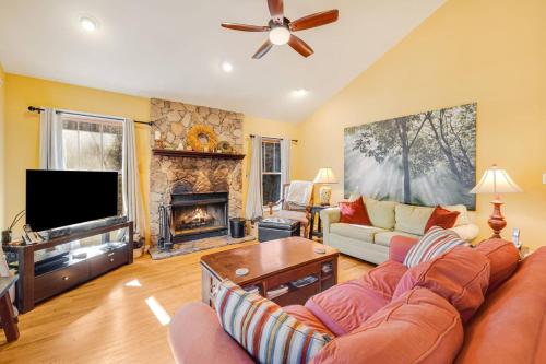 a living room with a couch and a fireplace at Maple Gap Cabins - 66 Acre Nature Retreat with TWO Charming Cabins in Brevard