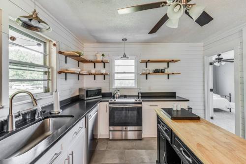 a kitchen with a sink and a ceiling fan at Redwing Farm Cottage - Mountain Views and Firepit! in Bedford