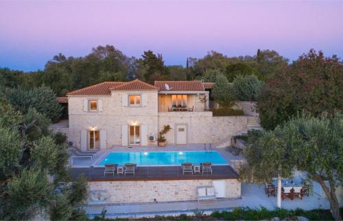 a house with a swimming pool in front of it at Kallista House in Kourtaíïka