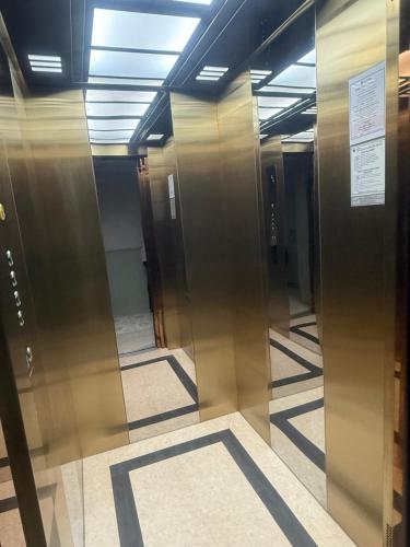 a hallway with elevator doors in a building at TUAN Hotel Bangkok near Wat Arun in Bangkok Yai