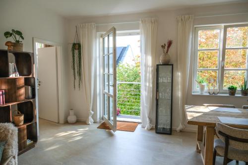 a living room with a door open to a patio at Zenkoje - Ihr Ferienzuhause in der Pfalz! in Neustadt an der Weinstraße