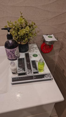 a table with a book and a vase of flowers at bahria enclave apartments in Islamabad