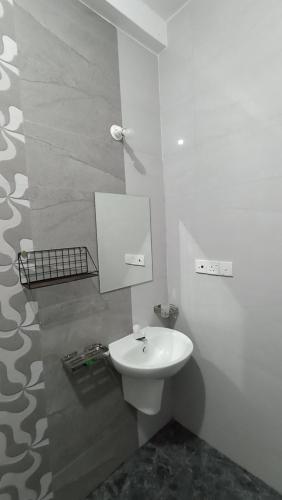 a bathroom with a white toilet and a sink at APV Home in Trincomalee