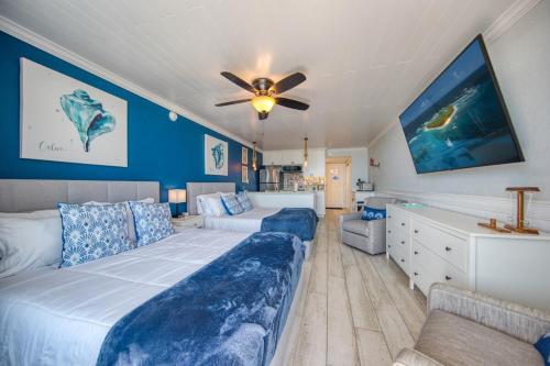 a bedroom with a large bed and a ceiling fan at EPIC Gulf & Beach Views with Balcony, Beach Supplies, & Pool in St. Pete Beach