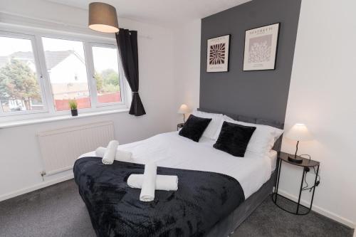 a bedroom with a large bed with white sheets and pillows at Contractors-Relocation-Free Parking-M5 Junction2 in Oldbury