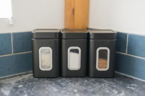 three trash cans sitting next to a wall at Contractors-Relocation-Free Parking-M5 Junction2 in Oldbury