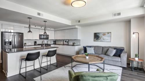 a kitchen and living room with a couch and a table at Amazing Apt in Midtown in Atlanta