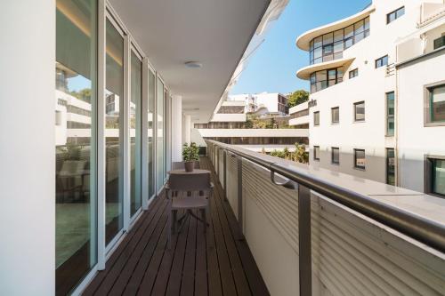 a balcony of a building with a chair on it at GuestReady - Premium stay in Funchal in Funchal