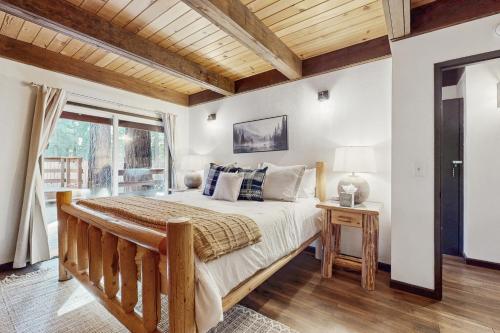 a bedroom with a large bed and a window at Charming Cabin in Bijou