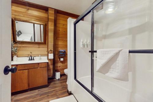 a bathroom with a shower and a sink at Charming Cabin in Bijou
